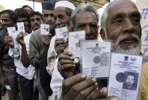 Voters show their voter identity cards at polling booth in Bhopal