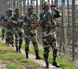 India's Border Security Force soldiers patrol along the fenced border with Pakistan in Ranbir Singh Pura sector